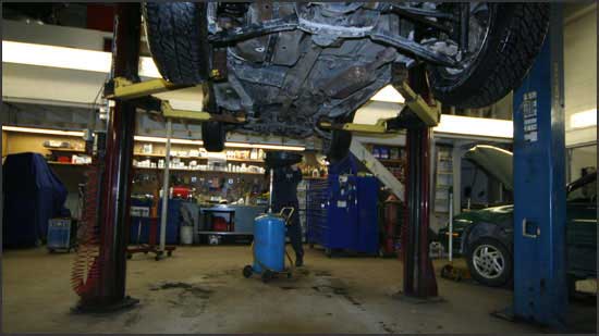 A car on a lift in the service bay