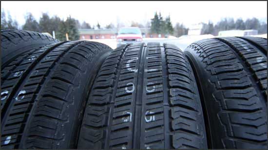 A row of tires lined up outside the shop